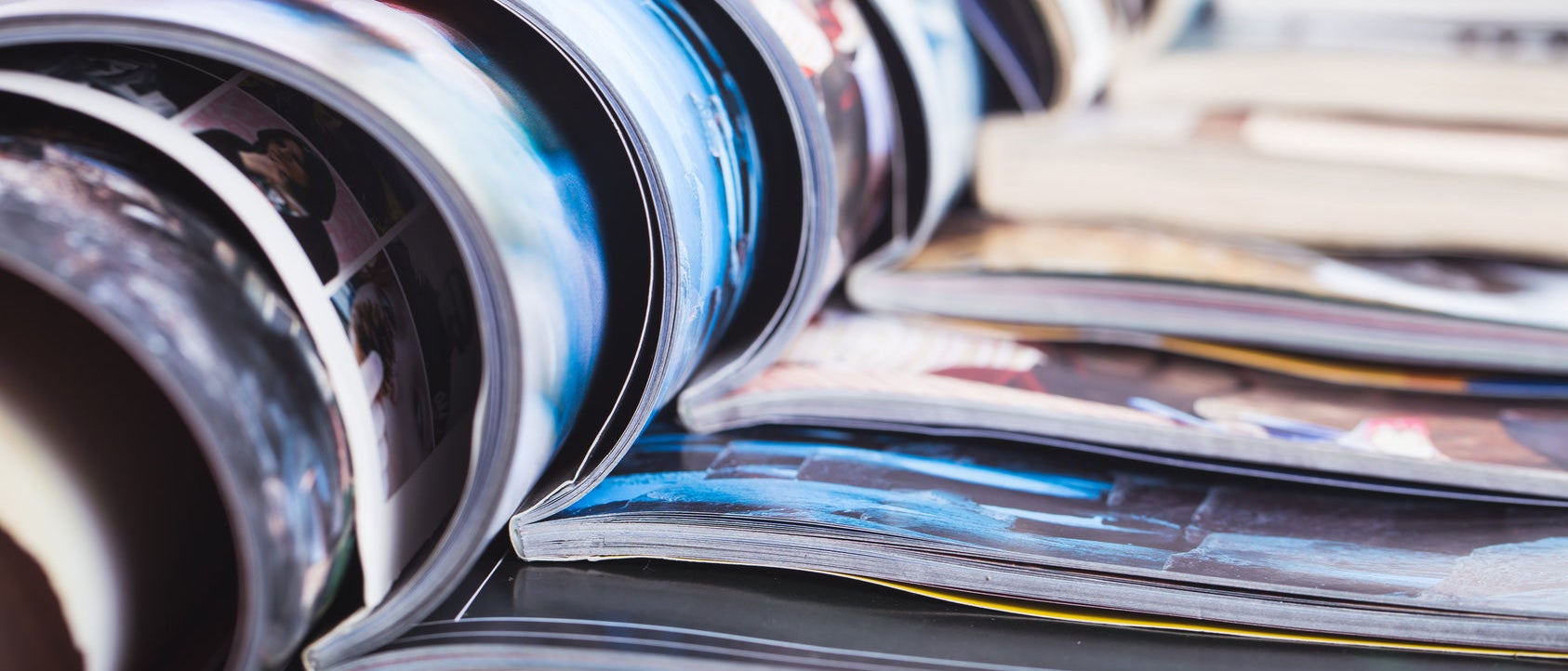 stack of open colorful magazines. information