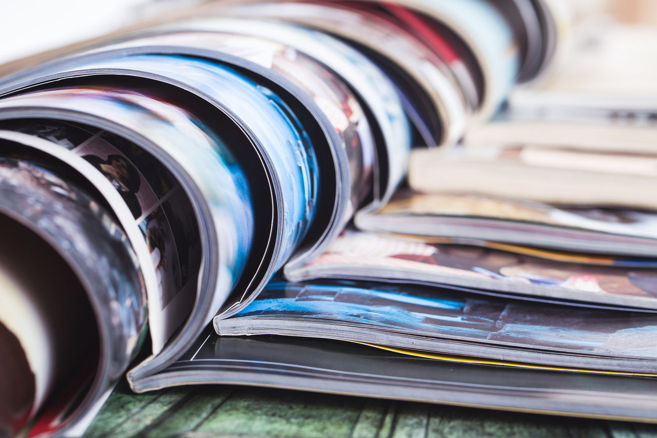 stack of open colorful magazines. information