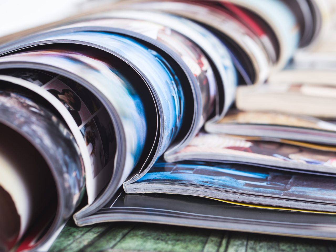 stack of open colorful magazines. information