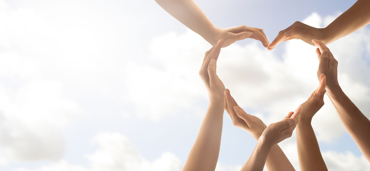 Symbol and shape of heart created from hands.The concept of unity, cooperation, partnership, teamwork and charity.